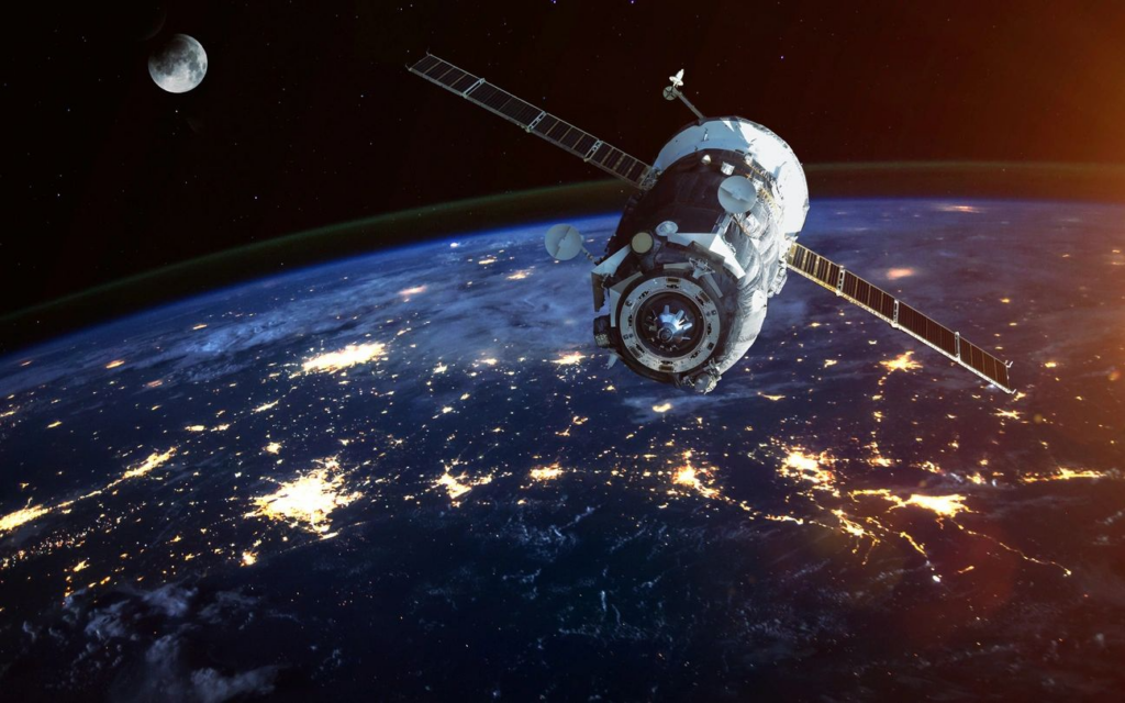 Satellite above Earth showing illuminated city lights